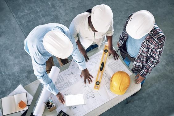 Engineering team reviewing technical plans